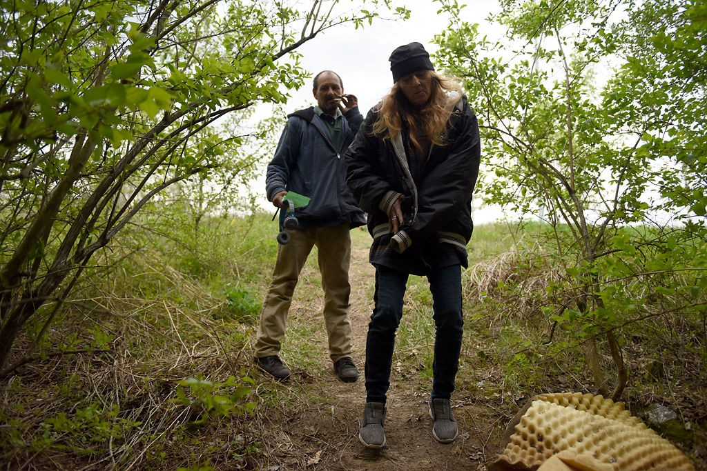 Bobby Hall, left, and Diana Welch walk down a path to a familiar campsite